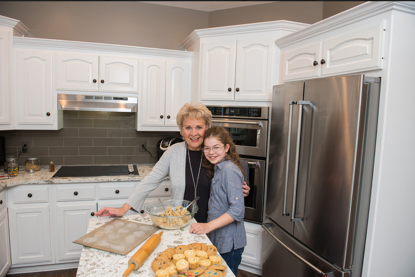 Grandmother and granddaughter cooking in kitchen