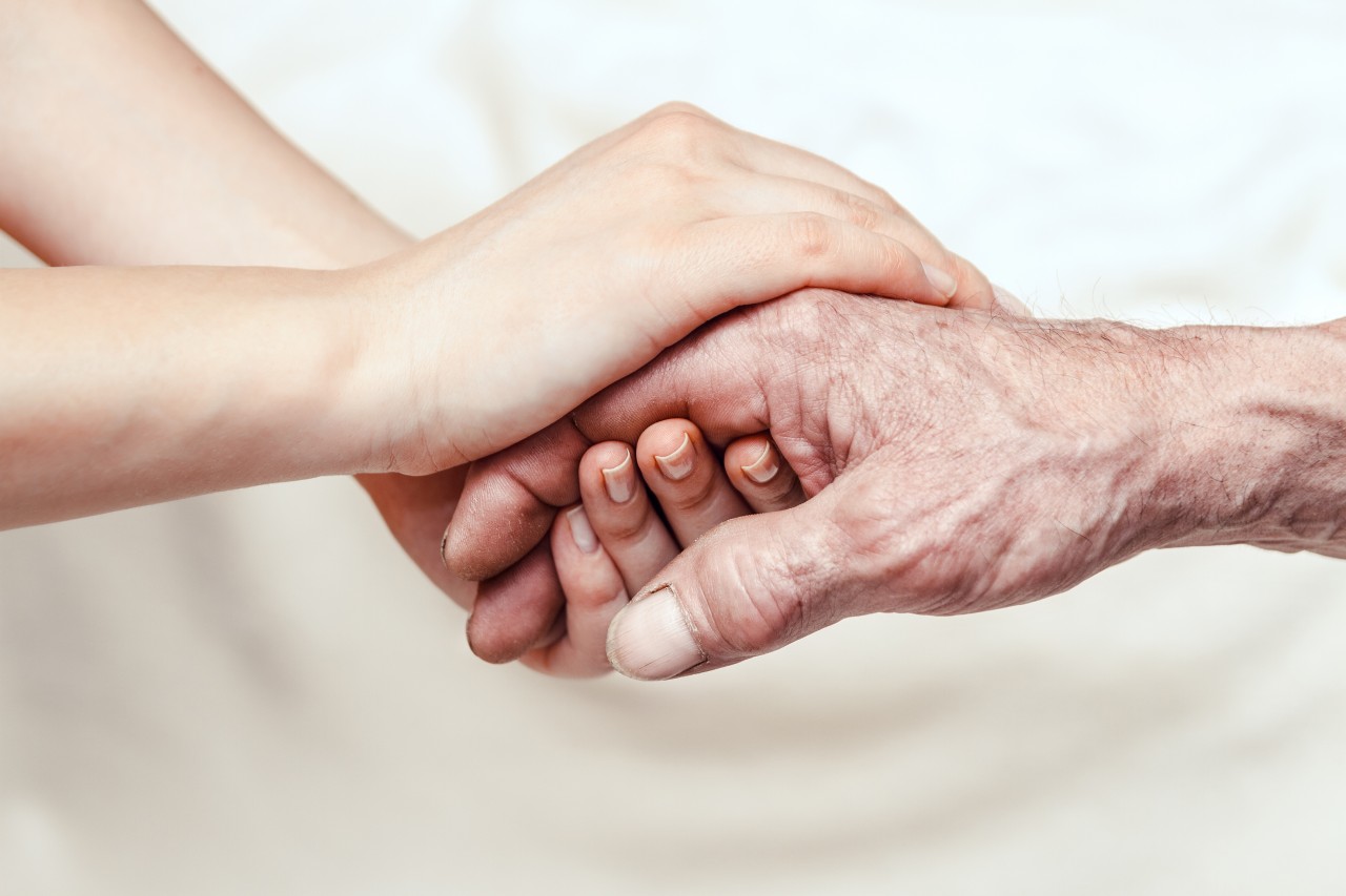 Nurse holding the hand of a patient